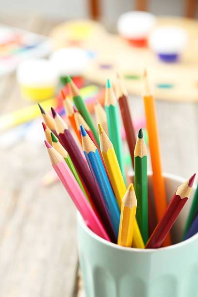 istock Colorful pencils in cup on grey wooden background 464899688