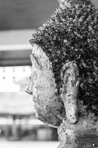 the side of buddha statue in buddhist temple church, black and white