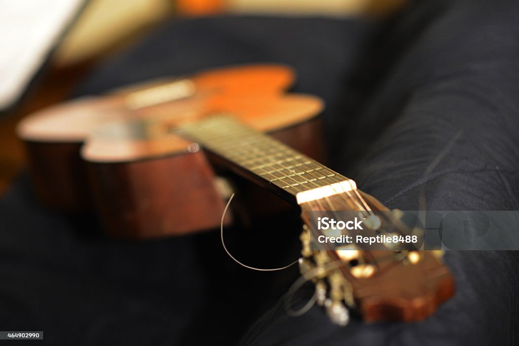Artistic shot of a guitar with selective focus Selective focus on a guitar. defocused shot of a guitar with depth of narrowed to create an artistic concept. Its a single guitar on a sofa. 2015 Stock Photo