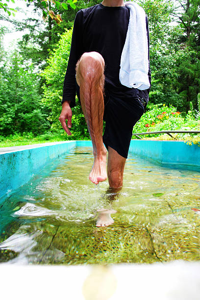 Close-up of a man getting into water