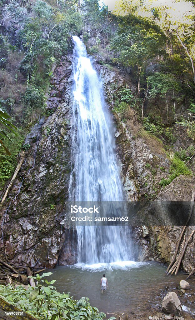 man againts waterfall Mae Gone Waterfall, Chaing Rai , Thailand Adult Stock Photo