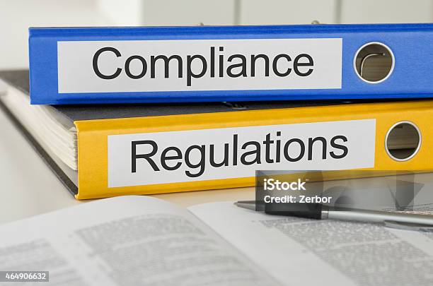 Folders With The Label Compliance And Regulations Stock Photo - Download Image Now - Obedience, Conformity, Law