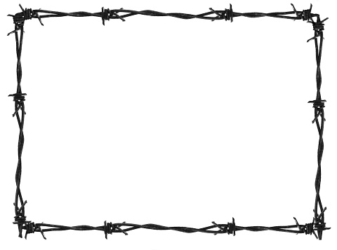 Barbed Wire Fence. Prison or border fence with razor wire against dark sky. Security concept