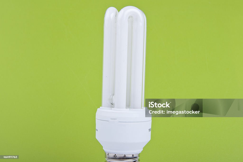 bulb on green background modern energy saving bulb on green background Abstract Stock Photo