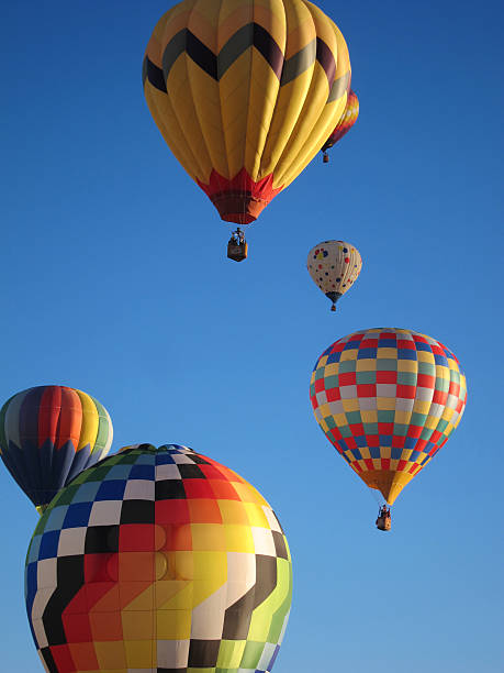 istock Hot air balloons float in blue cloudless sky 464912346