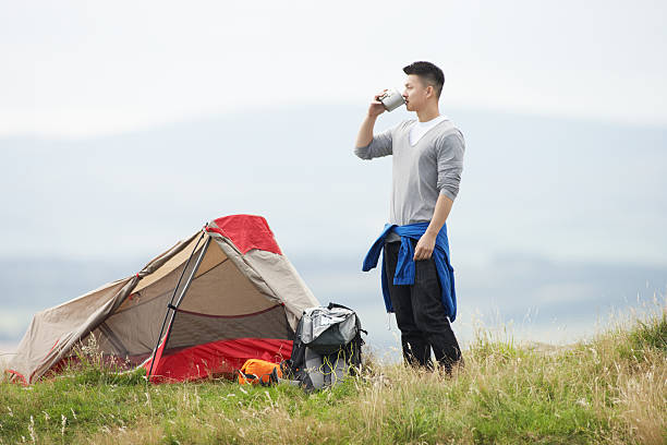 Young Man On Camping Trip In Countryside On His Own