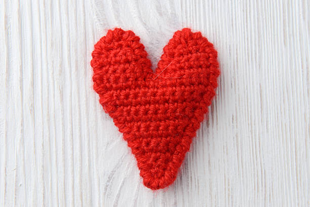 istock red heart on white wooden background 464917001