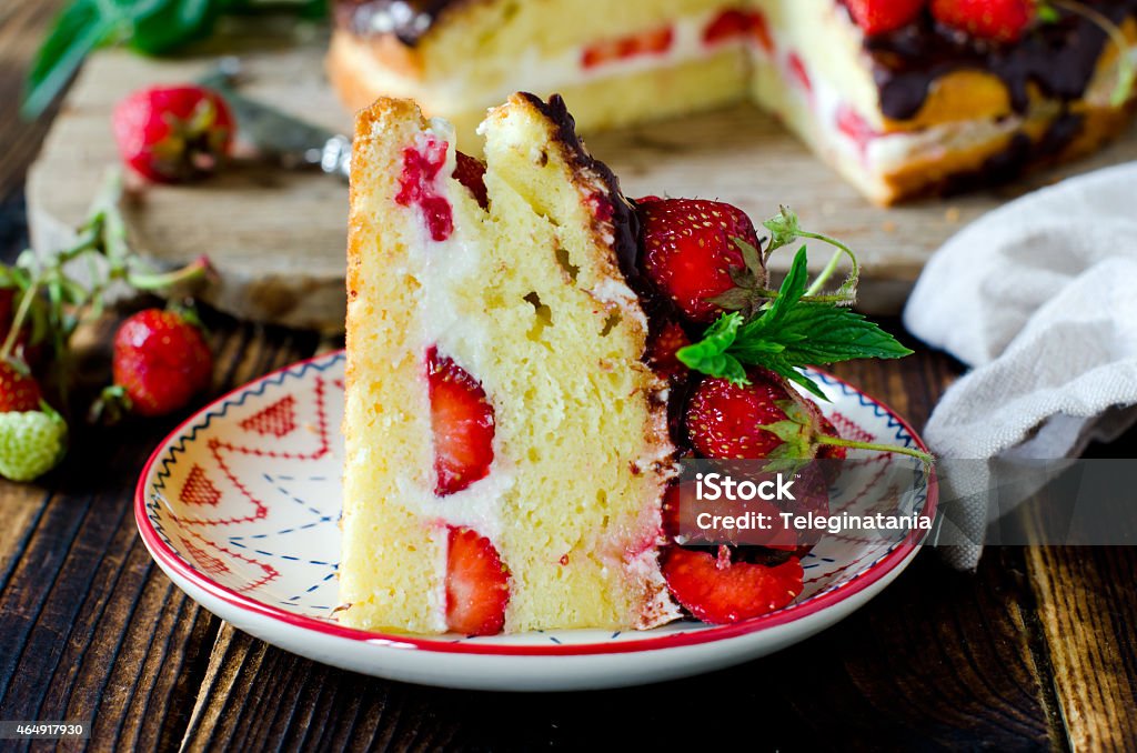 Sponge cake with cream, strawberries and chocolate 2015 Stock Photo