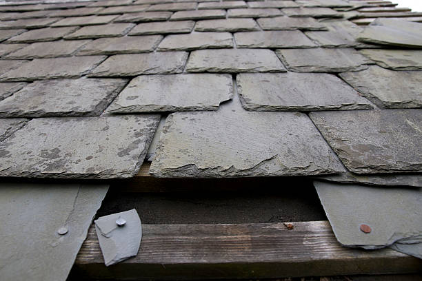 istock damaged roof with missing slates 464921154