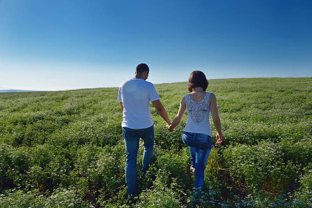 istock happy couple in wheat field 464922711