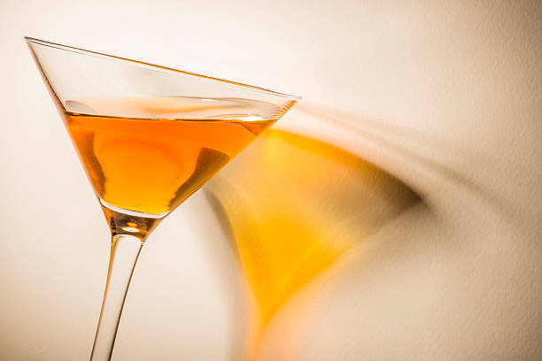 istock Orange liqueur into a martini glass on white background. 464927762