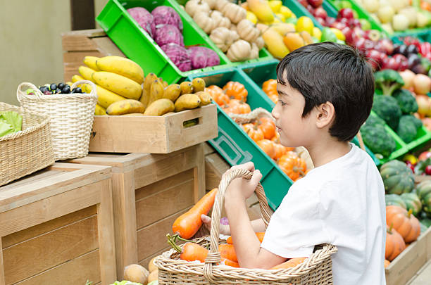 istock Little boy help by shpping in the market 464928868
