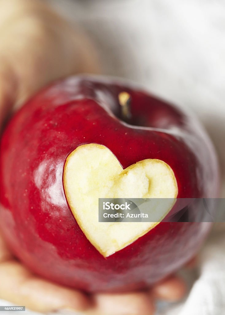 Hand holding red apple with heart Animal Stock Photo
