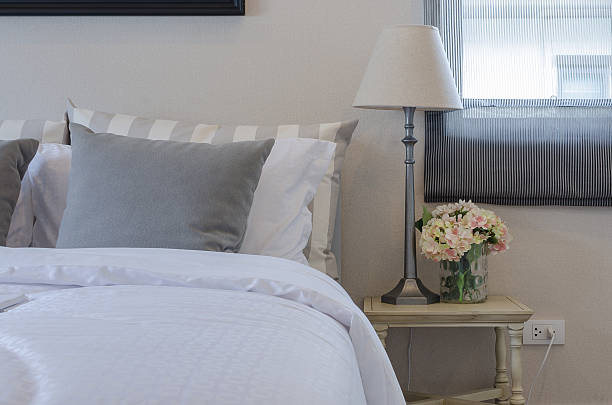 istock grey pillow on bed with lamp and plant 464934230