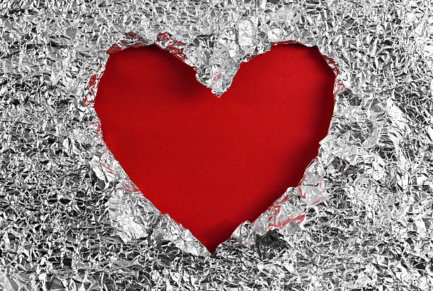 istock Heart hole in aluminum foil 464934617