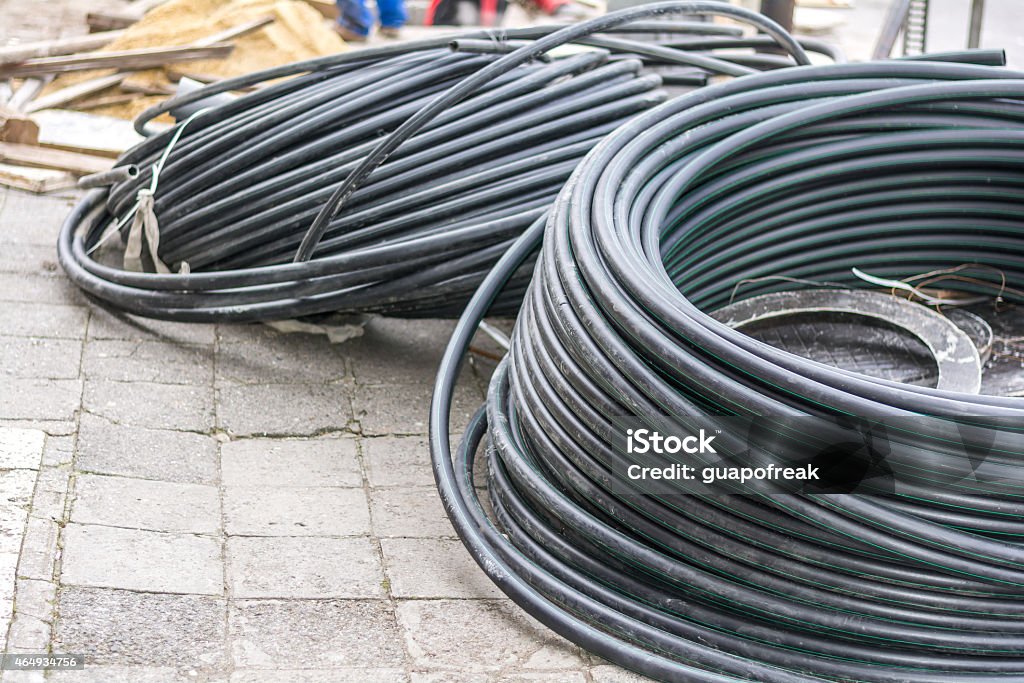 hoses on the street during urban renovation tubes on the street during city repairing Hydraulic Platform Stock Photo