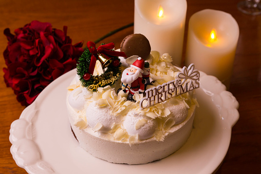 christmas cake with a candle and a flower