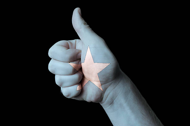Hand with thumb up gesture in colored somalia national flag as symbol of excellence, achievement, good, - for tourism and touristic advertising, positive political, cultural, social management of country