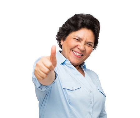 Portrait of happy senior woman with thumb up isolated over white