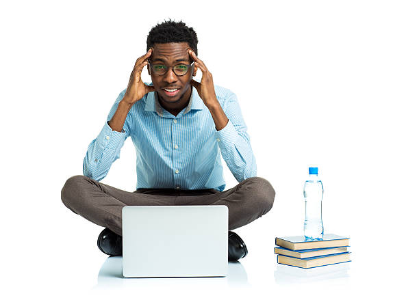istock African american college student with headache sitting on white 464943798