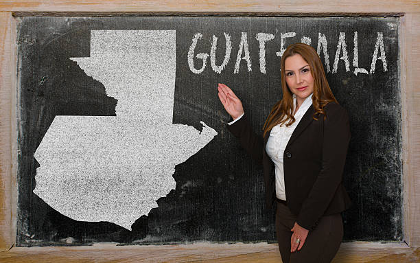 istock Teacher showing map of guatemala on blackboard 464944078