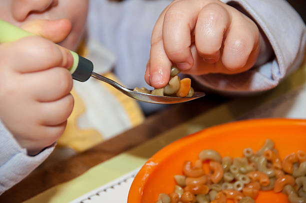 istock Young children try to eat pasta 464946527