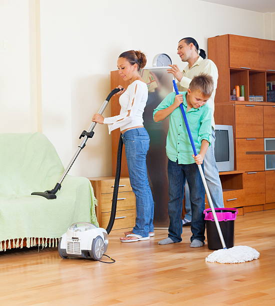 istock Family vacuuming at home 464947025