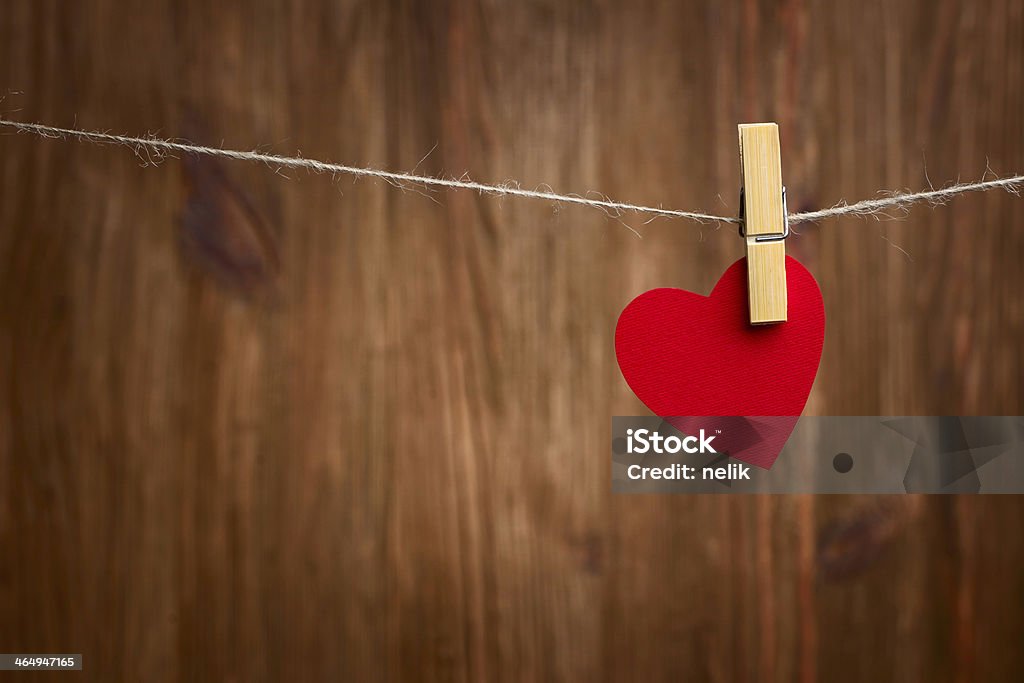 red heart hanging on wooden background Love heart hanging on wooden texture background, valentines day card concept Abstract Stock Photo