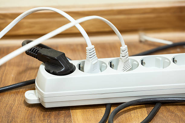 istock Many plugs plugged into electric power bar on office floor 464947625