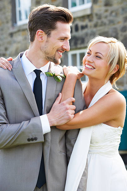 istock Romantic Bride And Groom Embracing Outdoors 464949339