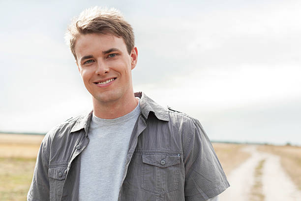 istock Portrait of handsome young man standing on field 464949661