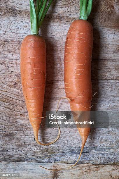 Two Organic Carrots On A Chopping Board Stock Photo - Download Image Now - 2015, Carrot, Close-up