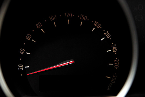 Car speedometer with black background and white digits.