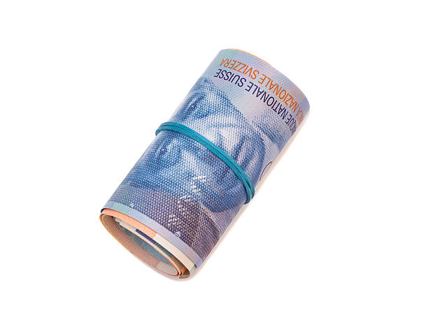 istock Swiss francs in a roll on white background 464959398