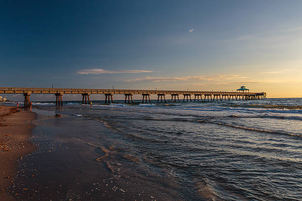istock Fishing Pier at Sunrise with Blue Sky and White Clouds 464959480