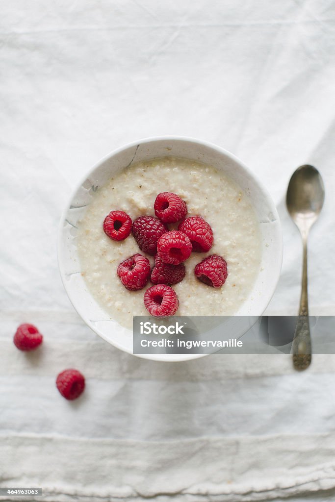 Porridge with raspberries Oat porridge with fresh raspberries on white background Berry Fruit Stock Photo