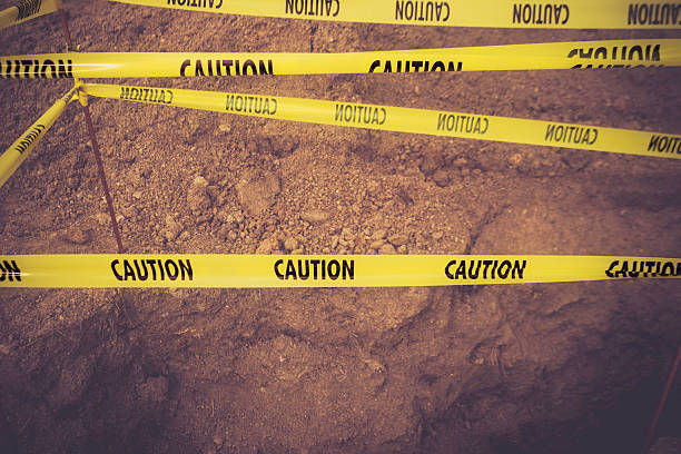 istock Caution tape around deep hole. Health and safety concepts. 464967292