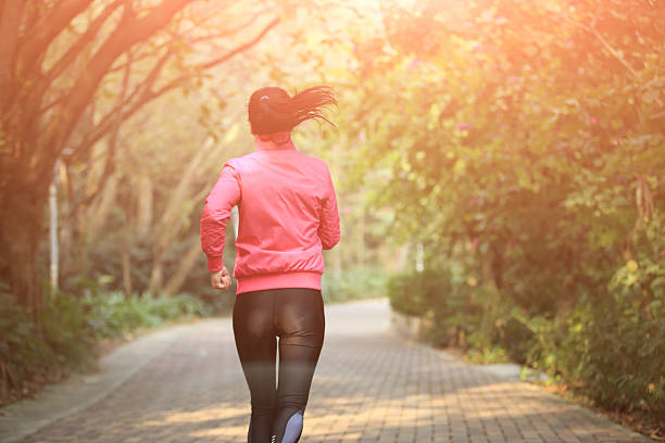 sporty woman morning exercise jogging at forest trail