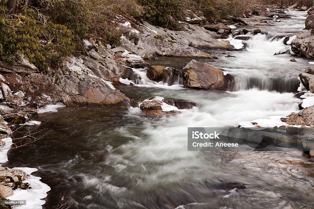 Mountain Stream in Great Smoky Mountains National Park Mountain stream flowing through ice covered rocks in Great Smoky Mountains National Park in the winter near Gatlinburg, Tennessee Beauty In Nature Stock Photo