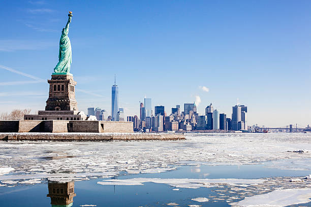 Statue of Liberty NYC Skyline Frozen Hudson River Brooklyn Bridge Ice sheets form around Statue of Liberty and NYC. One World Trade Center. Brooklyn Bridge, right. Hudson river freezes over from arctic weather. hudson river photos stock pictures, royalty-free photos & images