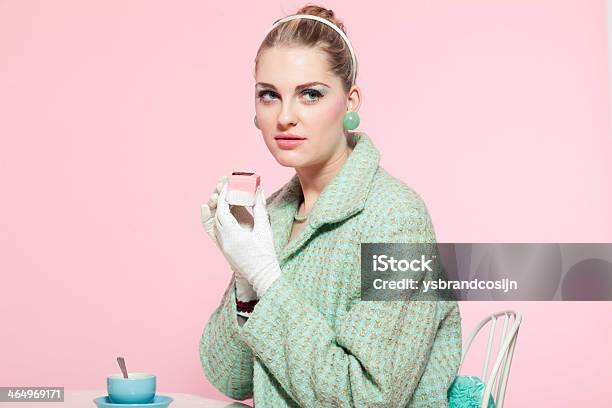 Girl Blonde Hair Fifties Fashion Style Eating Cup Cake Stock Photo - Download Image Now