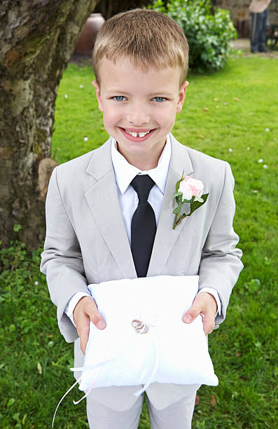 istock Page Boy Carrying Wedding Ring On Cushion 464969555