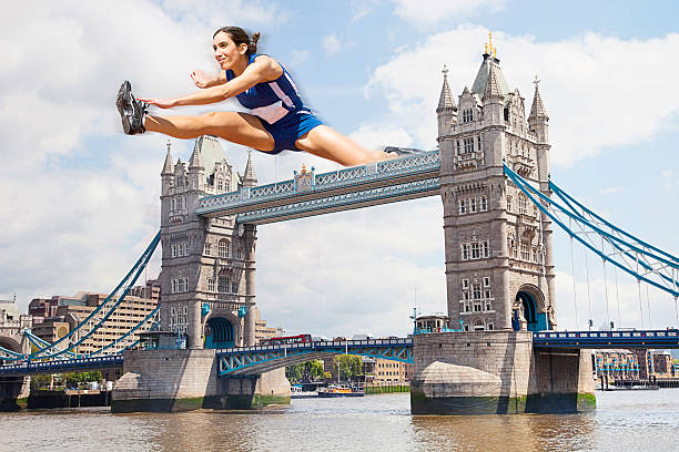 female athlete бег с барьерами тауэрский мост - hurdle people england tower bridge стоковые фото и изображения