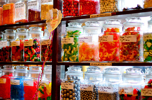 Candy shop A old fashioned candy jar in a shop located in Banff. There is a sign which reads that these candies will make great stocking stuffers.  candy jellybean variation color image stock pictures, royalty-free photos & images