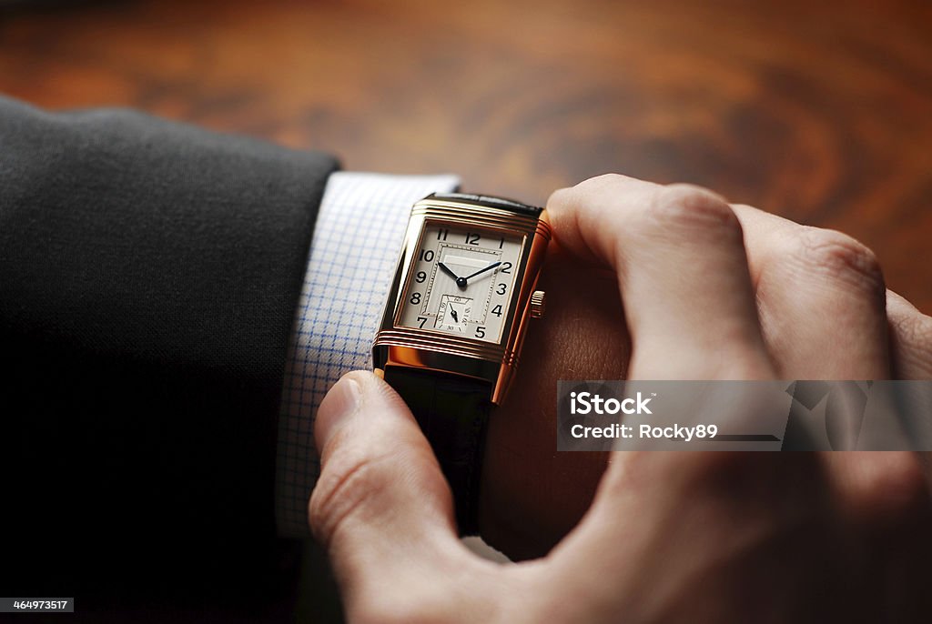Time to go Businessman checking his wristwatch - nice shot over the shoulder. It's time to go to the next appointment. Watch - Timepiece Stock Photo