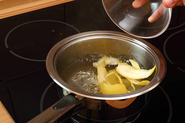 istock Add lemon peel into saucepan with boiling syrup 464975347