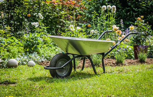 Work in garden-wheelbarrow on the front of flower bed