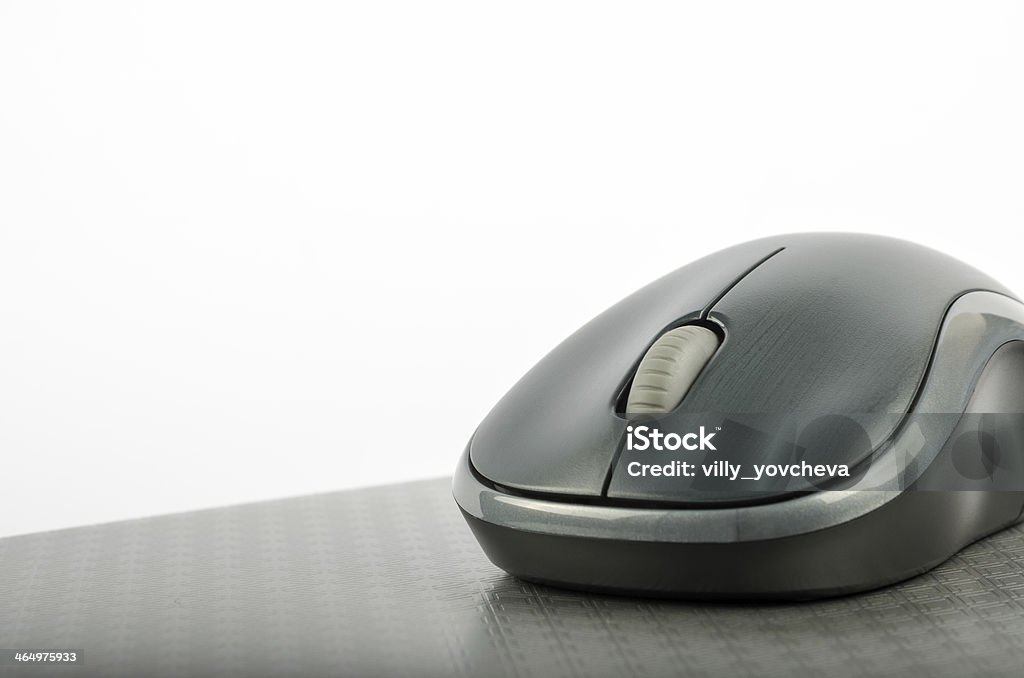 Wireless computer mouse on a metallic gray background Wireless computer mouse on a metallic background Black Color Stock Photo