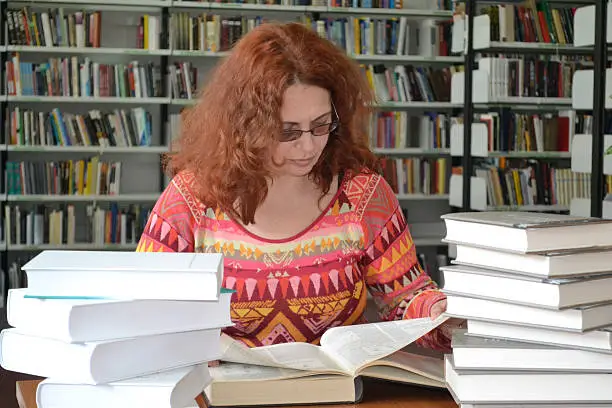 Researcher in a library browsing the encyclopedia.