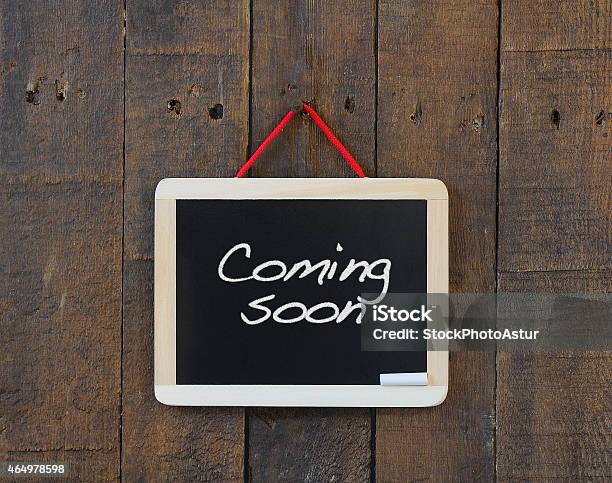 Coming Soon Sign Nailed To A Wooden Wall Stock Photo - Download Image Now - Opening, Sign, Coming Soon Sign